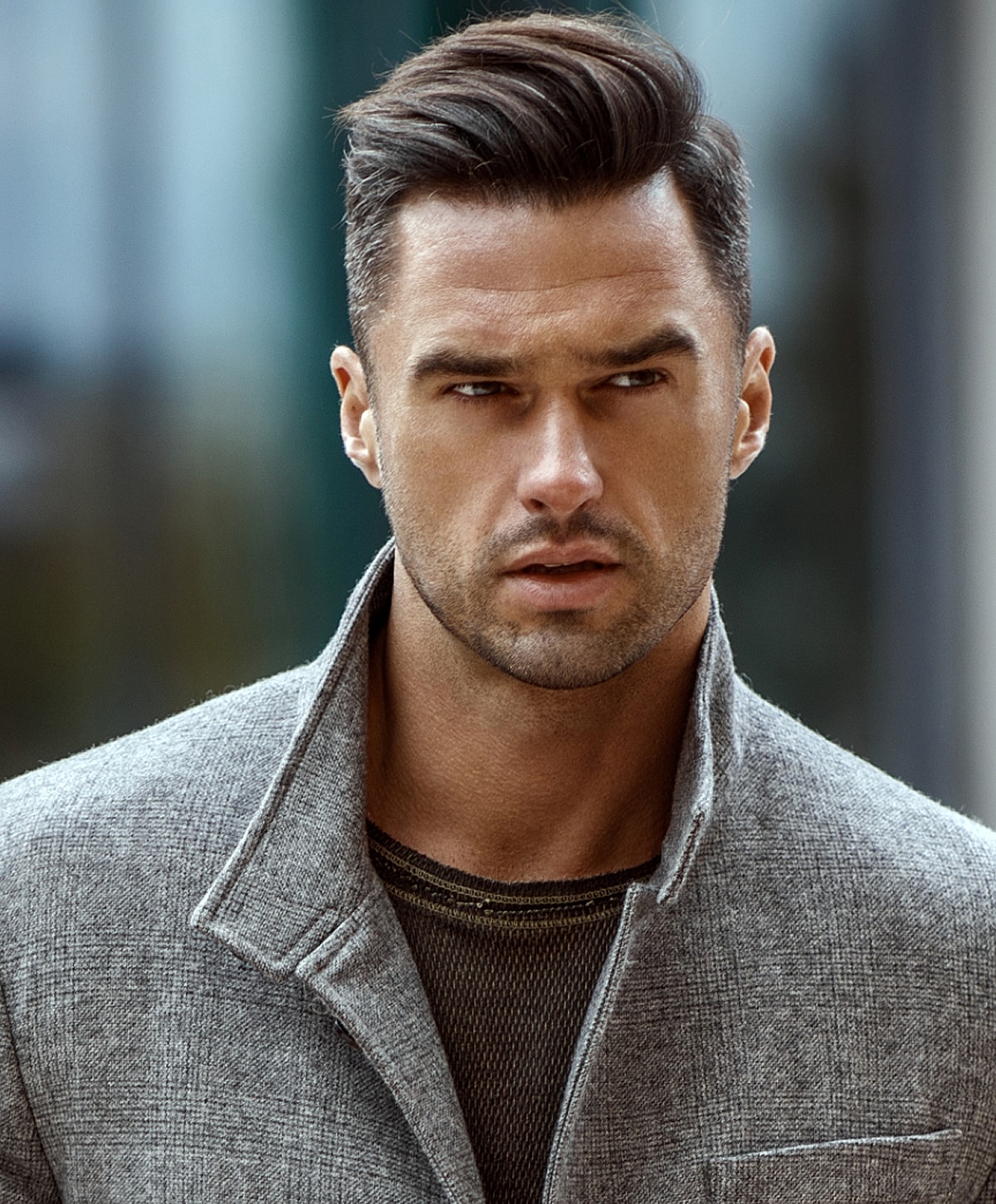 Stylish man with a confident expression outdoors.